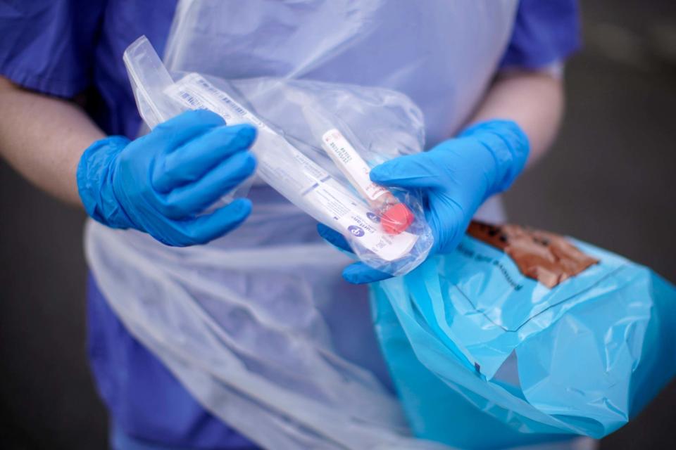 A NHS nurse holds a Coronavirus testing kit (Getty Images)