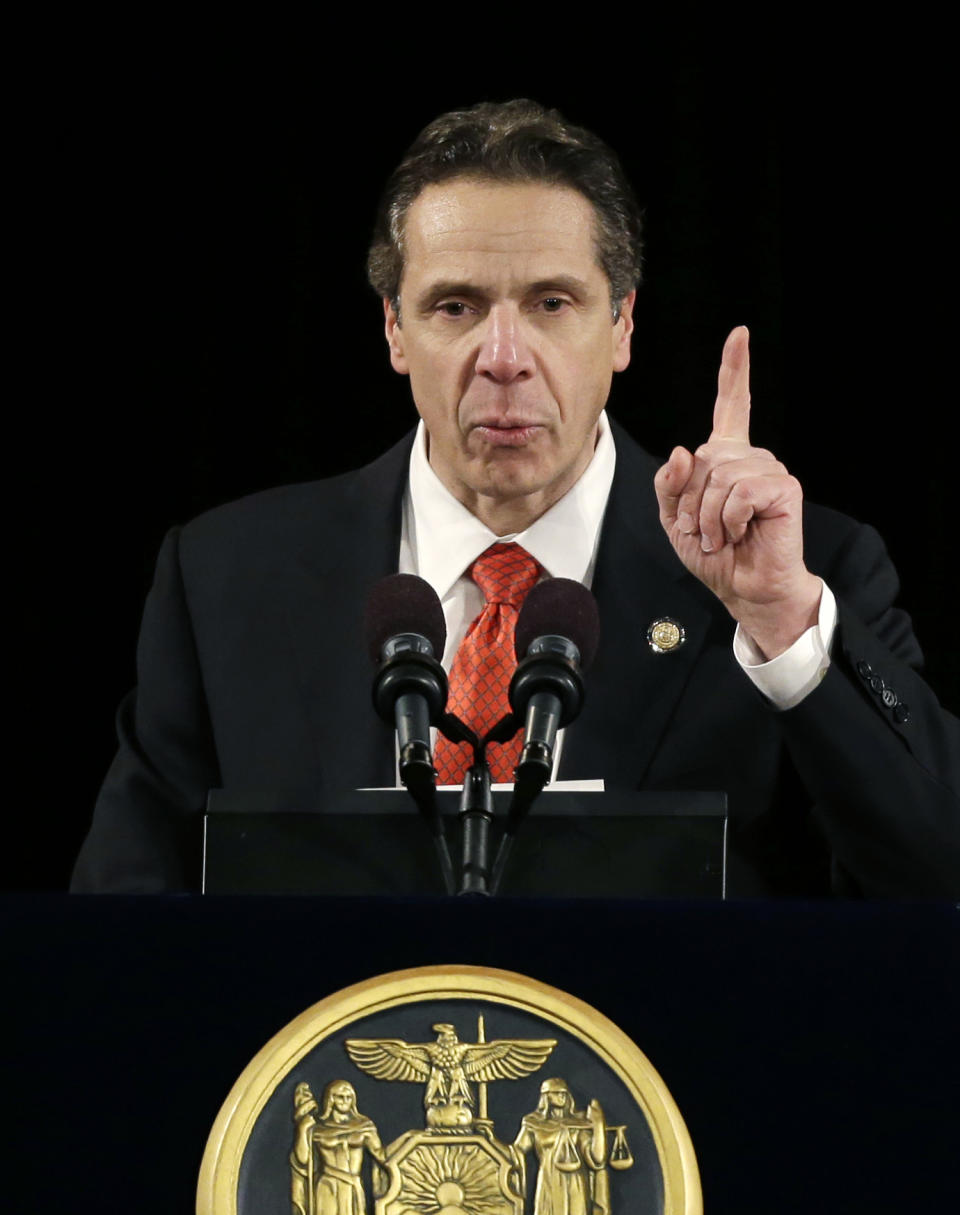 FILE - In this Jan 8, 2014 file photo, New York Gov. Andrew Cuomo delivers his annual State of the State address at the Empire State Plaza Convention Center in Albany, N.Y. A slow but steady economic recovery is generating more tax revenue than many states had anticipated, offering elected officials tantalizing choices about whether to ply voters with tax breaks, boost spending for favorite programs or sock away cash for another rainy day. The Democratic New York Governor wants to tap a surplus to roll back recent tax hikes, despite other Democrats’ ideas for new spending. (AP Photo/Mike Groll)