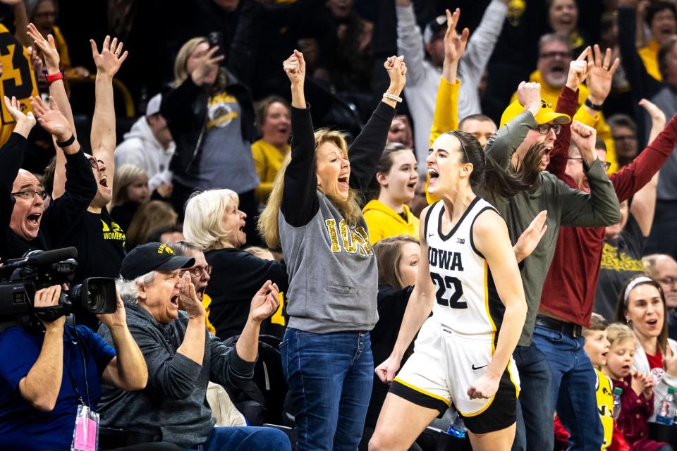 Iowa guard Caitlin Clark (22) reacts after making a 3-point basket setting the record for all-time leading scoring during a NCAA Big Ten Conference women's basketball game against Michigan, Thursday, Feb. 15, 2024, at Carver-Hawkeye Arena in Iowa City, Iowa.