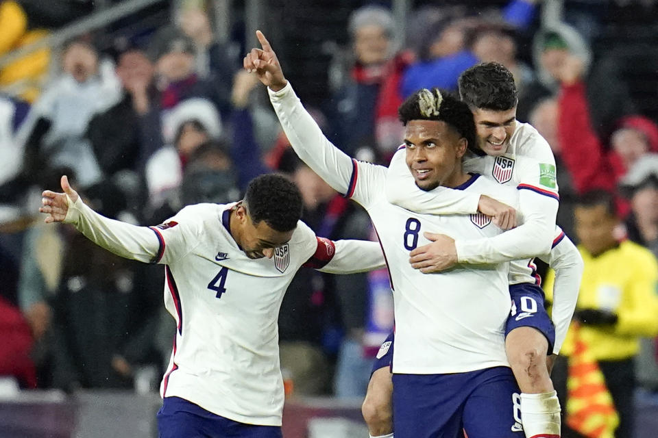 United States' Weston McKennie celebrates his goal with Tyler Adams, left, and Christian Pulisic during the second half of a FIFA World Cup qualifying soccer match against Mexico, Friday, Nov. 12, 2021, in Cincinnati. The U.S. won 2-0. (AP Photo/Julio Cortez)
