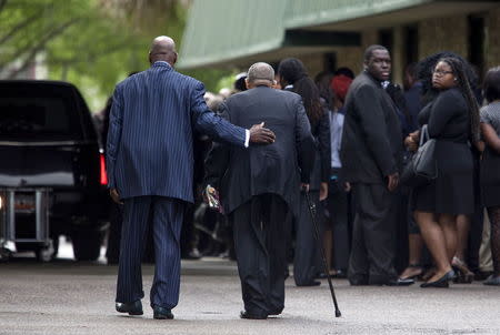 Mourners wait outside the W.O.R.D. Ministry Christian Center in Summerville, South Carolina, April 11, 2015. REUTERS/Randall Hill