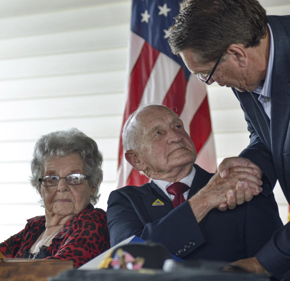 Terre Haute Mayor Duke Bennett shakes hands with WWII veteran Jimmie Royer after proclaming that Sunday, September 29 was officially Jimmie Royer day in Terre Haute at Sunday's ceremony where Royer was awarded the Legion of Honor award from a French Consul General in Terre Haute, IN. (Austen Leake/Tribune-Star via AP)