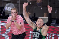 Toronto Raptors head coach Nick Nurse, left, and Boston Celtics' Daniel Theis (27) react during the second half of an NBA conference semifinal playoff basketball game Friday, Sept. 11, 2020, in Lake Buena Vista, Fla. (AP Photo/Mark J. Terrill)