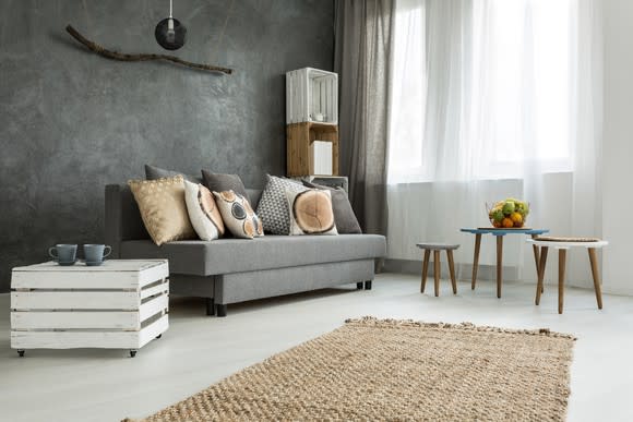 A living room with a couch, table, and chairs.