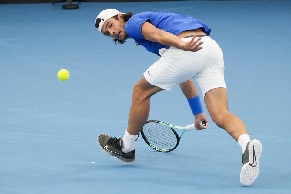 Italy's Lorenzo Musetti plays a forehand return to United States' Frances Tiafoe during the final of the United Cup tennis event in Sydney, Australia, Sunday, Jan. 8, 2023. (AP Photo/Mark Baker)