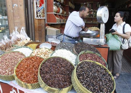 A Syrian woman buys seeds at a market in old Damascus, September 10, 2013. REUTERS/Khaled al-Hariri