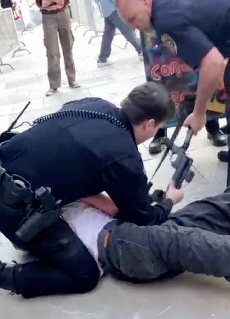 A San Luis Obispo police officer arrests a protester during an pro-Palestine demonstration at Cal Poly on Jan. 23, 2024.