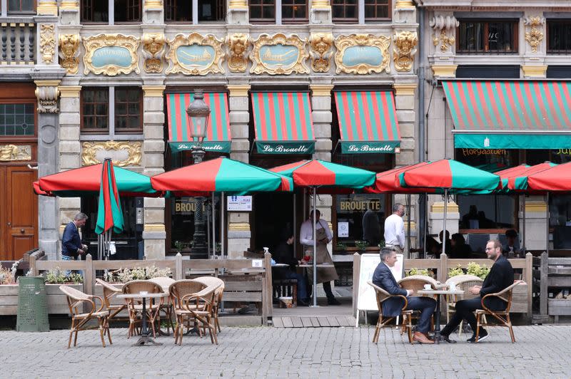 People sit on a terrace as restaurants and bars reopen after weeks of lockdown restrictions amid the coronavirus disease (COVID-19) outbreak, in Brussels