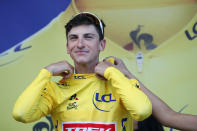 Italy's Giulio Ciccone puts on the overall leader's yellow jersey on the podium, at the end of the sixth stage of the Tour de France cycling race over 160 kilometers (100 miles) with start in Mulhouse and finish in La Planche des Belles Filles, France, Thursday, July 11, 2019. (AP Photo/Christophe Ena)