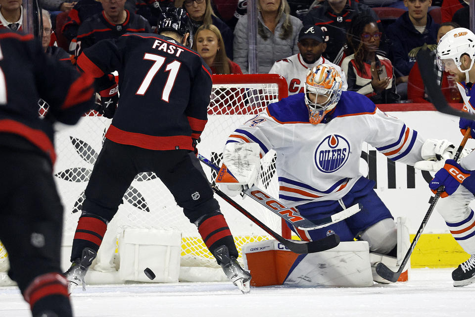 Carolina Hurricanes' Jesper Fast (71) slips the puck past Edmonton Oilers goaltender Stuart Skinner for a goal during the first period of an NHL hockey game in Raleigh, N.C., Wednesday, Nov. 22, 2023. (AP Photo/Karl B DeBlaker)