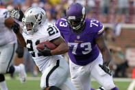 FILE PHOTO: Aug 8, 2014; Minneapolis, MN, USA; Minnesota Vikings defensive tackle Sharrif Floyd (73) tackles Oakland Raiders running back Maurice Jones-Drew (21) during the first quarter at TCF Bank Stadium. Mandatory Credit: Brace Hemmelgarn-USA TODAY Sports/File Photo