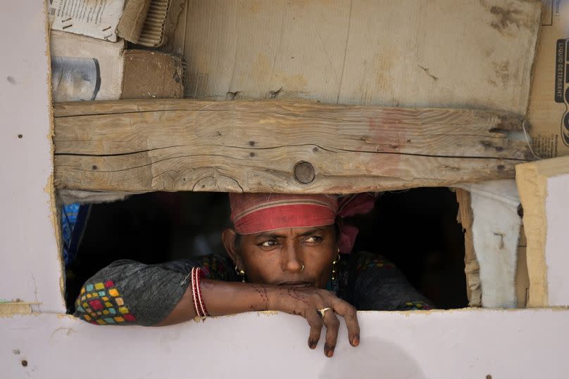 Waste picker Salmaa Shekh looks outside a temporary shelter at Jammu 