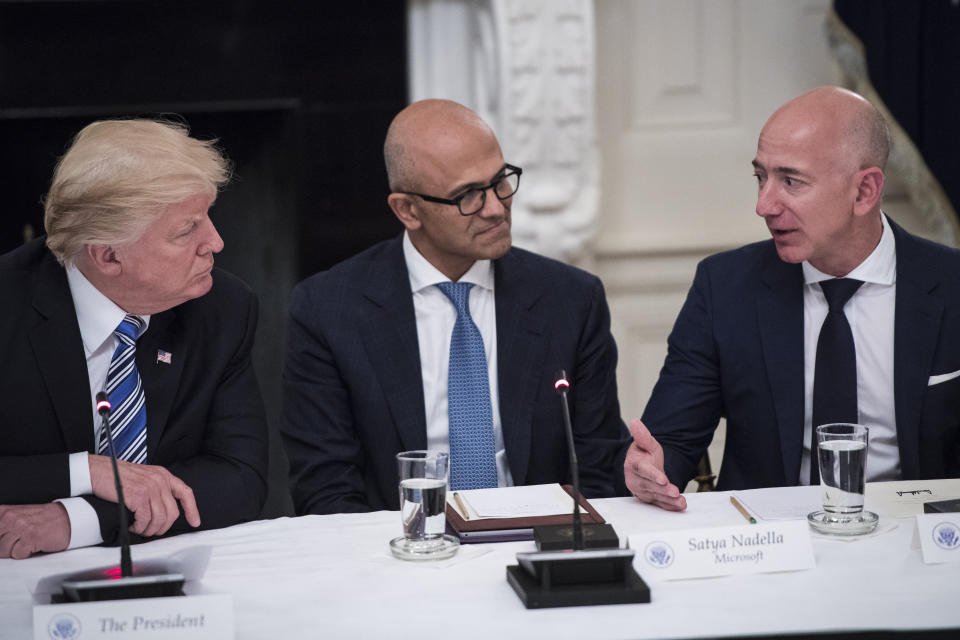 WASHINGTON, DC - JUNE 19: President Donald Trump speaks with Satya Nadella, Chief Executive Officer of Microsoft, and Jeff Bezos, Chief Executive Officer of Amazon during an American Technology Council roundtable in the State Dinning Room at the White House in Washington, DC on Monday, June 19, 2017. (Photo by Jabin Botsford/The Washington Post via Getty Images)