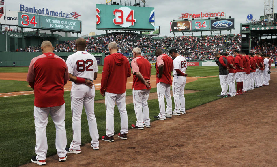 The Boston Red Sox and fans pause for a moment for former Red Sox designated hitter David Ortiz, who was shot Sunday evening in the Dominican Republic, prior to a baseball game against the Texas Rangers at Fenway Park in Boston, Monday, June 10, 2019. Ortiz is expected to return to the area to be treated at a Boston hospital. (AP Photo/Charles Krupa)