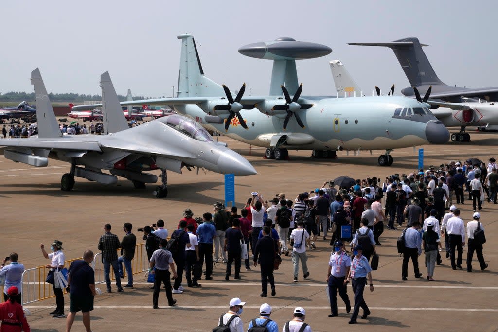 File photo. Visitors view the Chinese military's J-16D electronic warfare airplane, left, and the KJ-500 airborne early warning and control aircraft at right during 13th China International Aviation and Aerospace Exhibition on 29 September in Zhuhai in southern China's Guangdong province (Associated Press)