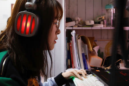 Zhang Shiyu, a 18-year-old student majoring in esports and management, practices in her dormitory room at the Sichuan Film and Television University in Chengdu, Sichuan province, China, November 19, 2017. REUTERS/Tyrone Siu