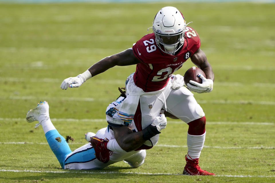 Arizona Cardinals running back Chase Edmonds is tackled by Carolina Panthers outside linebacker Shaq Thompson during the first half of an NFL football game Sunday, Oct. 4, 2020, in Charlotte, N.C. (AP Photo/Brian Blanco)