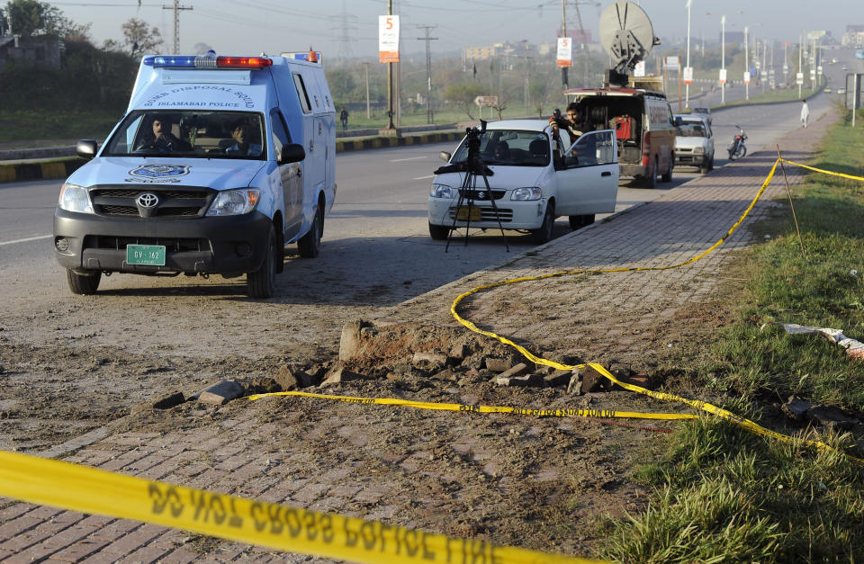 Police barricade the area of a blast in Islamabad, Pakistan, Thursday, April 3, 2014. A bomb exploded Wednesday near a convoy carrying former Pakistani President Pervez Musharraf who is on trial for treason, but the former ruler was not harmed, a police official and his spokeswoman said Thursday. (AP Photo/B.K. Bangash)