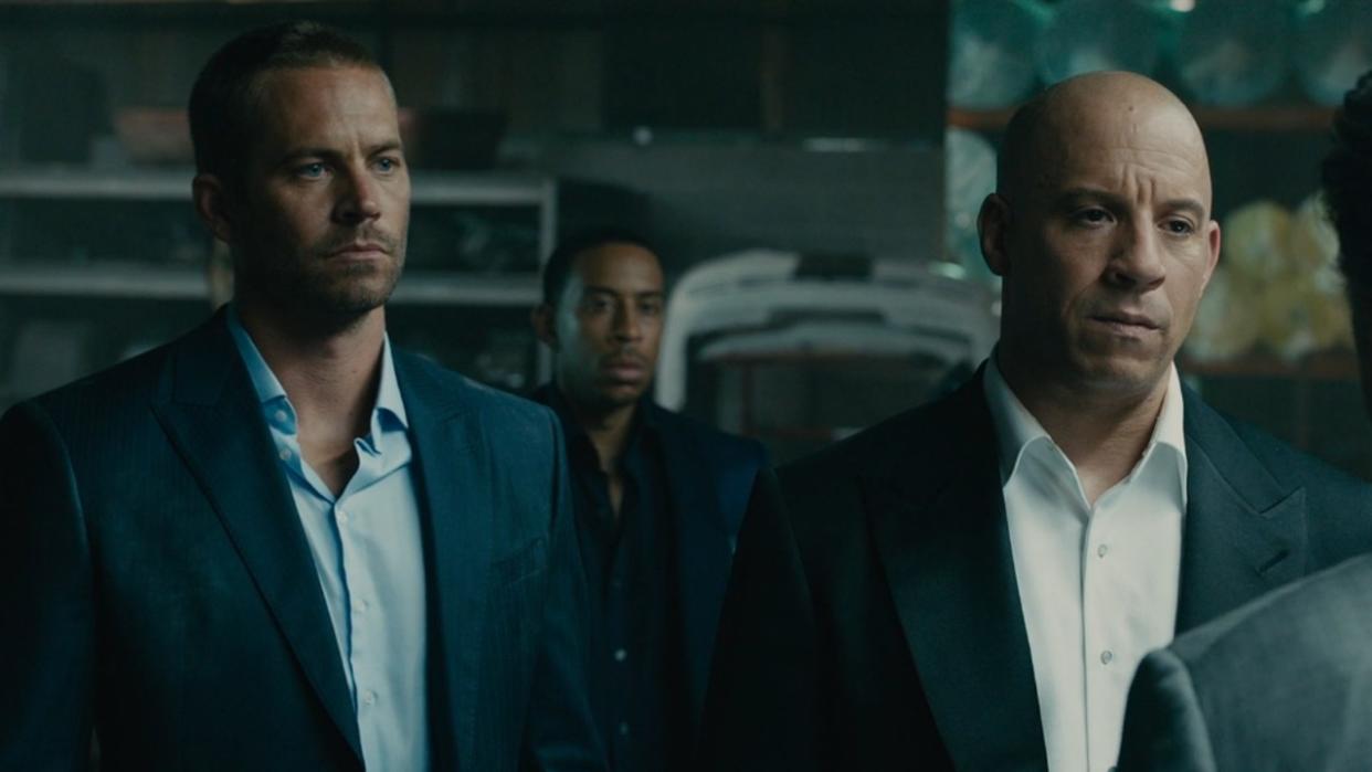  From left to right: Paul Walker, Ludacris in the background, and Vin Diesel in Furious 7 