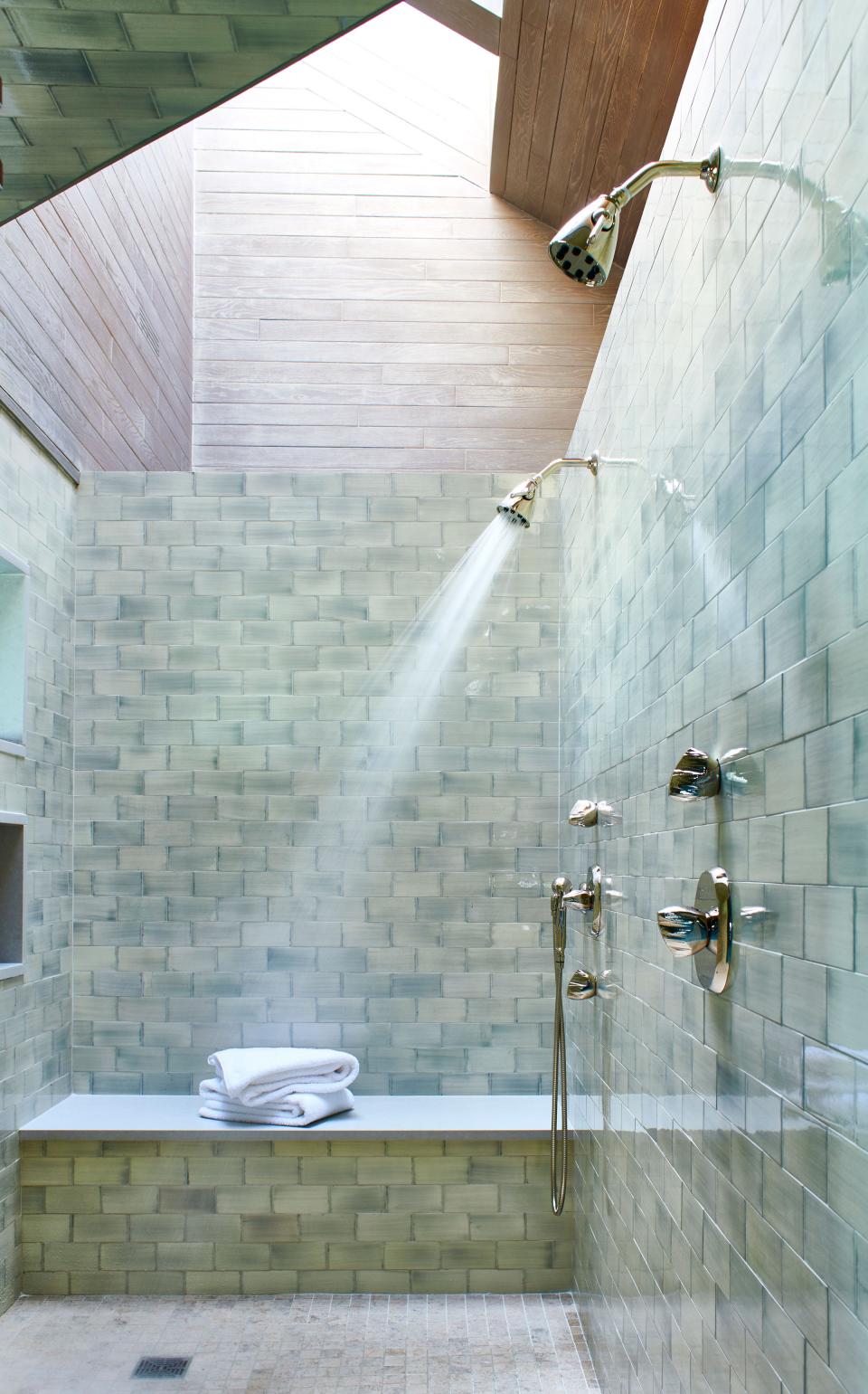 The walls of the renovated master bathroom feature Waterworks’ Claypaper handmade tiles in pewter glossy wash. Gascogne mosaics, also from Waterworks, cover the floor.