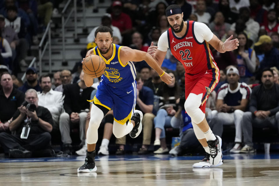 Golden State Warriors guard Stephen Curry (30) moves the ball down court past New Orleans Pelicans forward Larry Nance Jr. (22) in the first half of an NBA basketball game in New Orleans, Monday, Oct. 30, 2023. (AP Photo/Gerald Herbert)