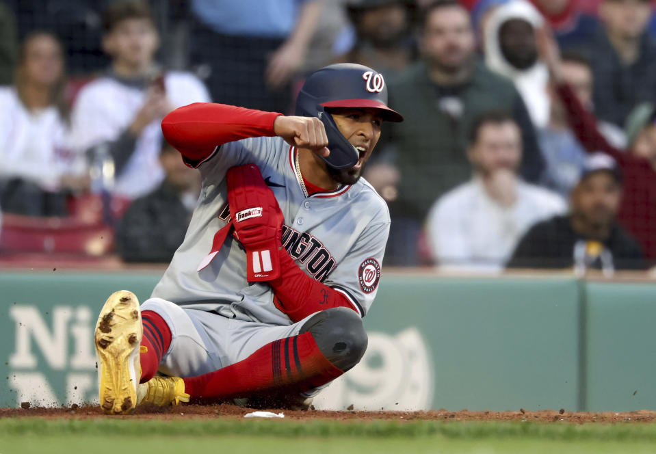 Washington Nationals' Eddie Rosario reacts after scoring against the Boston Red Sox during the second inning of a baseball game Friday, May 10, 2024, in Boston. (AP Photo/Mark Stockwell)