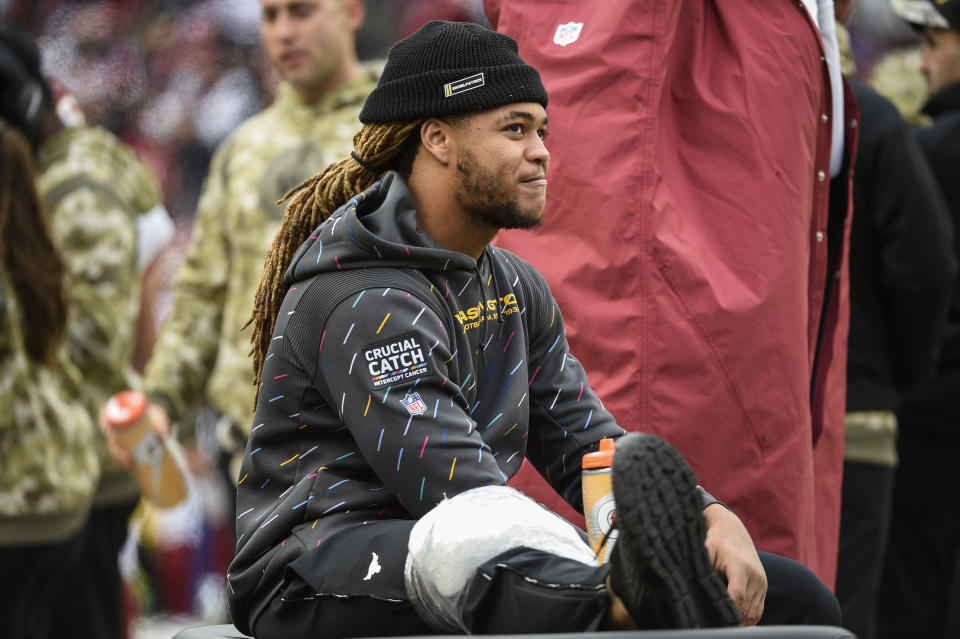 Washington Football Team defensive end Chase Young sits in the bench area with ice on his leg during the second half of an NFL football game against the Tampa Bay Buccaneers, Sunday, Nov. 14, 2021, in Landover, Md. (AP Photo/Mark Tenally)