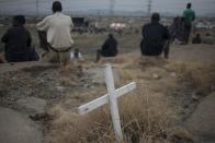 People gather on August 16, 2014 in Marikana next to the hill where, two years ago, miners where gunned down by South African police during a violent wave of strikes