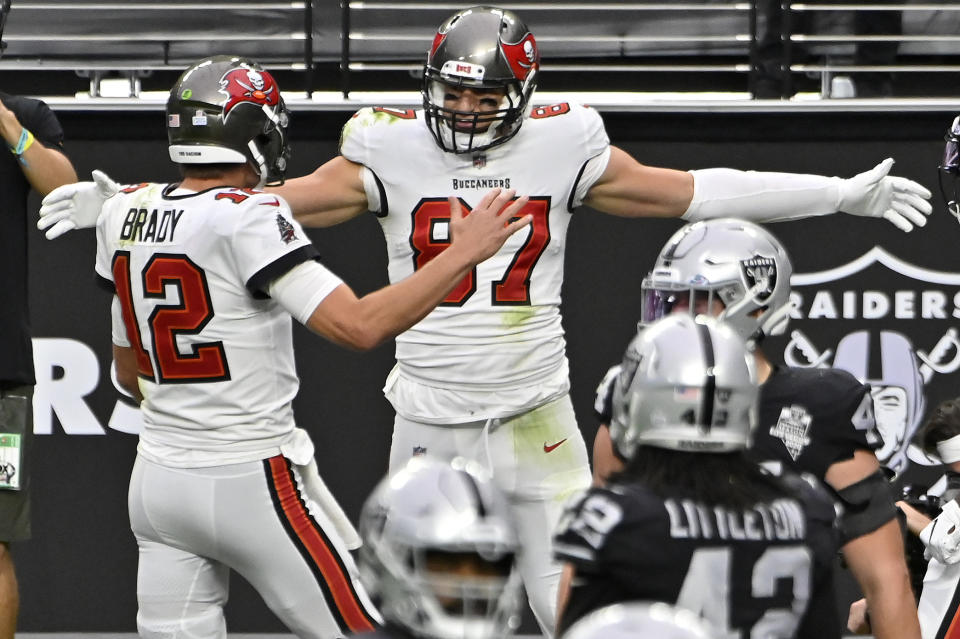 Tampa Bay Buccaneers tight end Rob Gronkowski celebrates with quarterback Tom Brady, left, after Gronkowski scored a touchdown against the Las Vegas Raiders during the first half of an NFL football game, Sunday, Oct. 25, 2020, in Las Vegas. (AP Photo/David Becker)