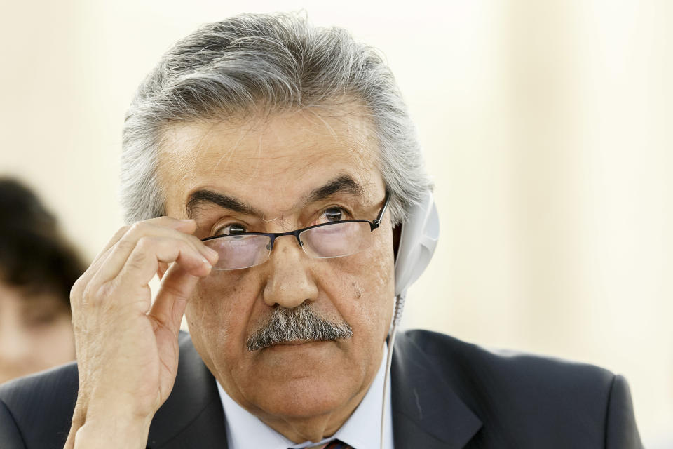 Faysal Khabbaz Hamoui, Ambassador of the Permanent Representative Mission of Syria to Geneva, listens to a speech, during a session of the Human Rights Council on the report of the Commission of Inquiry on Human Rights in Syria at the European headquarters of the United Nations in Geneva, Switzerland, Tuesday, March 18, 2014. (AP Photo/Keystone, Salvatore Di Nolfi)