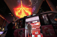 Residents visit a promotional event organized by sponsors of the 2022 Winter Olympics near a display of mascots of the Games at a mall in Beijing on Thursday, Feb. 10, 2022. The possibility of a large outbreak in the bubble, potentially sidelining athletes from competitions, has been a greater fear than any leakage into the rest of China. (AP Photo/Ng Han Guan)