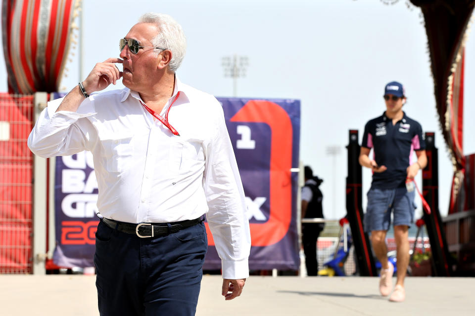 BAHRAIN, BAHRAIN - MARCH 31: Owner of Racing Point Lawrence Stroll walks in the Paddock followed by son Lance Stroll of Canada and Racing Point before the F1 Grand Prix of Bahrain at Bahrain International Circuit on March 31, 2019 in Bahrain, Bahrain. (Photo by Charles Coates/Getty Images)