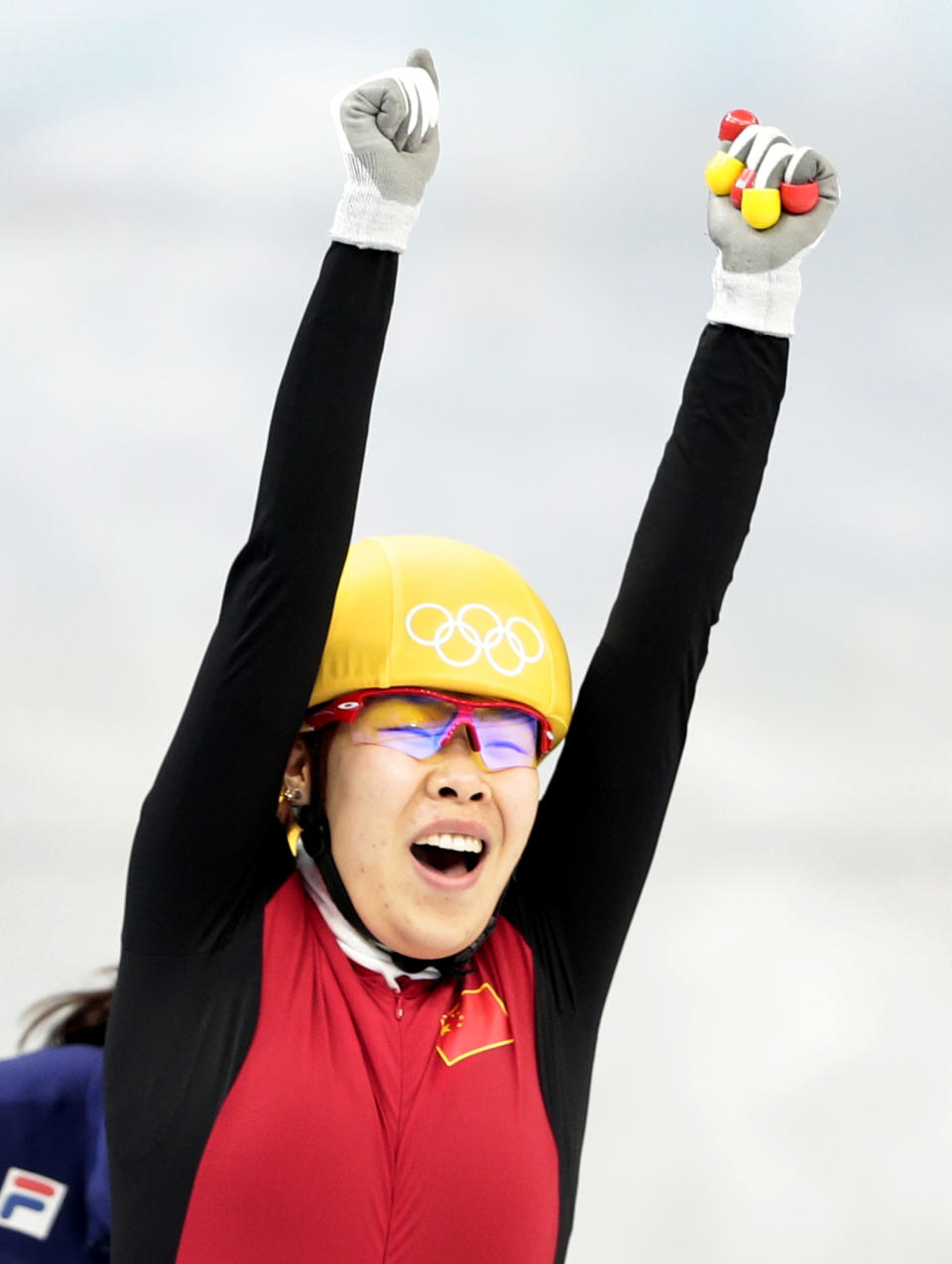 Zhou Yang of China celebrates as she crosses the finish line first in a women's 1500m short track speedskating final at the Iceberg Skating Palace during the 2014 Winter Olympics, Saturday, Feb. 15, 2014, in Sochi, Russia. (AP Photo/Ivan Sekretarev)