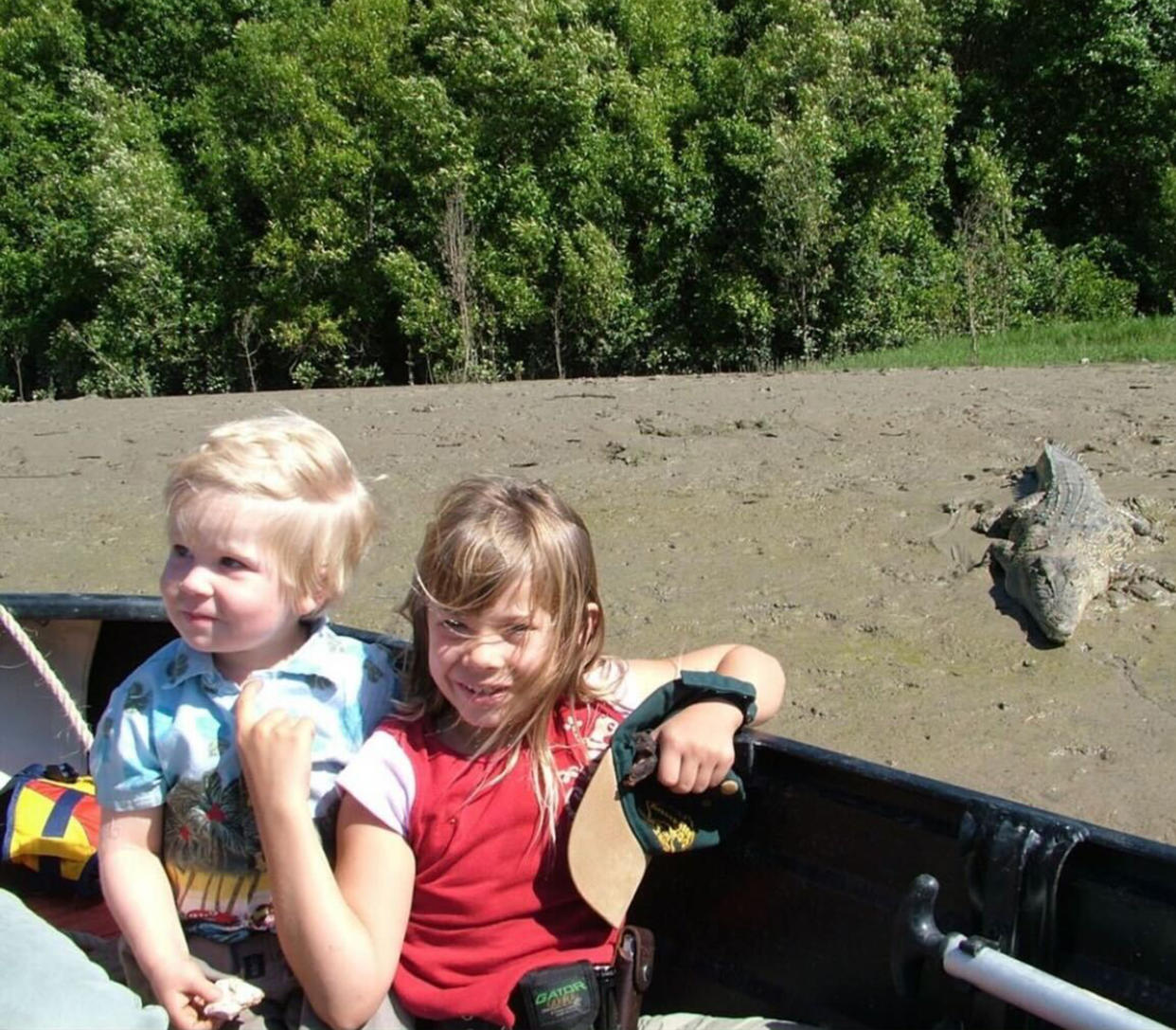 The Irwin siblings smile for a photo with a crocodile nearby. (Robert Irwin / Instagram)