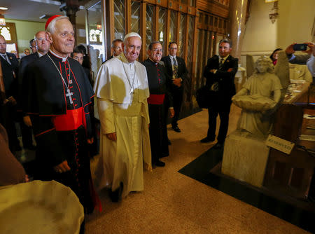 Pope Francis arrives with Cardinal Donald Wuerl (L) and Pastor Salvatore Criscuolo (R) to visit St. Patrick in the City Catholic church in Washington, D.C. September 24, 2015. REUTERS/Eric Lesser/Pool/Files