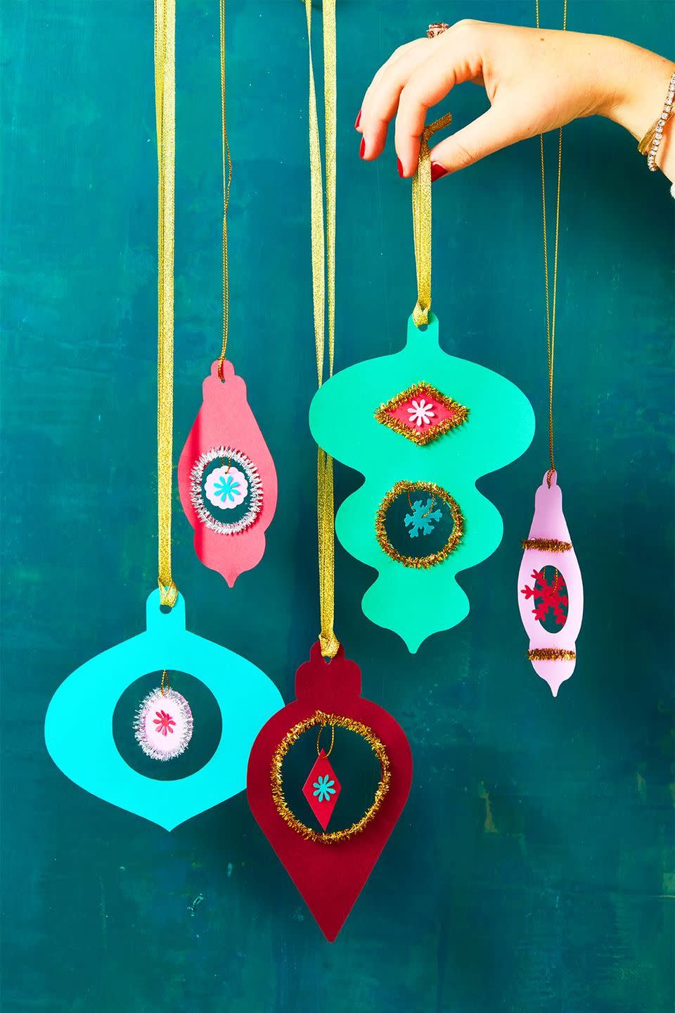 <p>For added dimension, mix a bunch of paper ornaments with multicolored baubles. To make, trace <a href="https://www.goodhousekeeping.com/holidays/christmas-ideas/a34373881/gh-holiday-templates/" rel="nofollow noopener" target="_blank" data-ylk="slk:our templates;elm:context_link;itc:0;sec:content-canvas" class="link ">our templates</a> onto card stock and cut them out. Decorate to your liking with glitzy pipe cleaners and snowflake cut-outs. Finally, punch a hole, add a ribbon and hang 'em on your Christmas tree. </p><p><a class="link " href="https://hmg-prod.s3.amazonaws.com/files/ghk-3dornament-templates-1607446670.pdf?tag=syn-yahoo-20&ascsubtag=%5Bartid%7C10055.g.34112389%5Bsrc%7Cyahoo-us" rel="nofollow noopener" target="_blank" data-ylk="slk:Shop Now;elm:context_link;itc:0;sec:content-canvas">Shop Now</a></p>