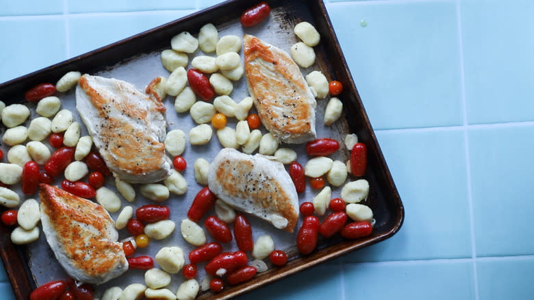 Gnocchi mixture scattered on tray with chicken