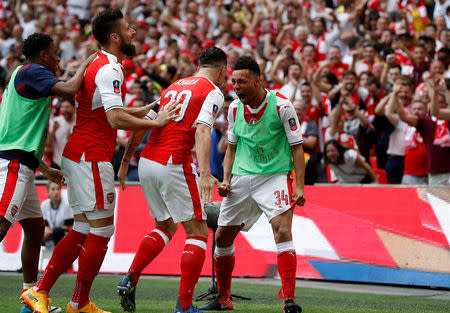 Britain Soccer Football - Arsenal v Chelsea - FA Cup Final - Wembley Stadium - 27/5/17 Arsenal’s Francis Coquelin, Olivier Giroud and Granit Xhaka celebrate after Aaron Ramsey (not pictured) scores their second goal Reuters / Darren Staples