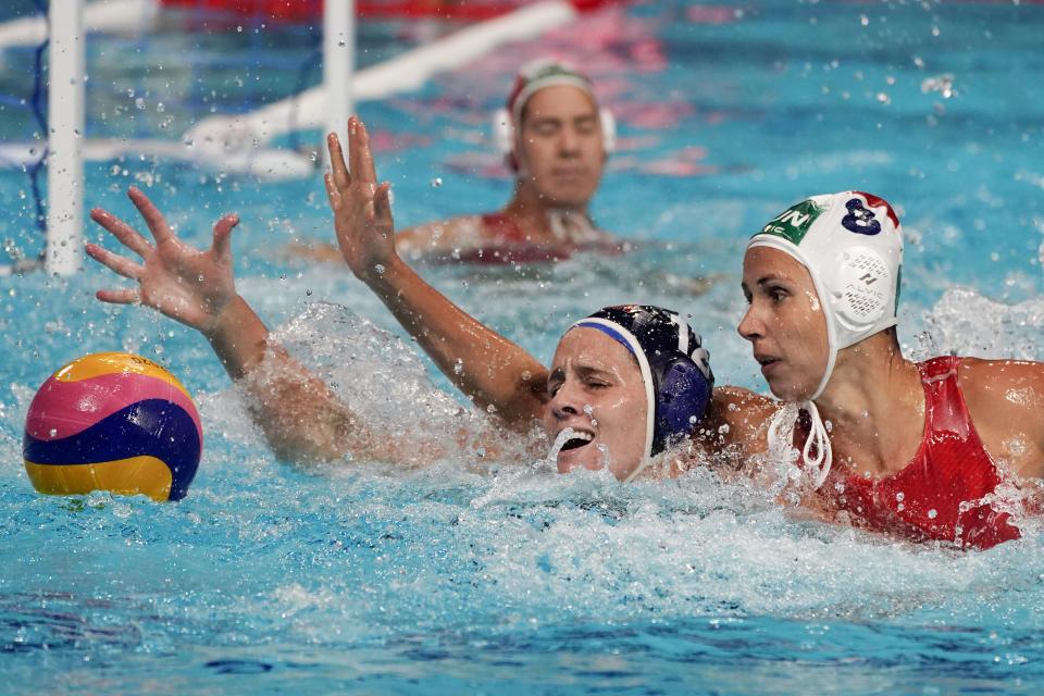 United States' Alys Williams (12) and Hungary's Rita Keszthelyi (8) reach for the ball during a preliminary round women's water polo match at the 2020 Summer Olympics, Wednesday, July 28, 2021, in Tokyo, Japan. (AP Photo/Mark Humphrey)