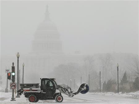 A snow sweeper attempts to keep a street open in front of the U.S. Capitol during a blizzard in Washington March 3, 2014. REUTERS/Gary Cameron