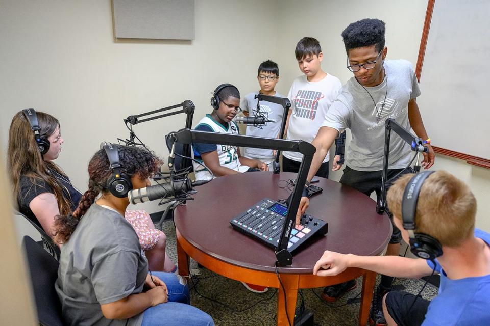 Kindred Locke of Knoxville, a senior entrepreneurship major at MTSU who also works with the Boys and Girls Clubs of Rutherford County, helps a group of club members learn about podcasting in the university's James E. Walker Library MakerSpace digital creation and design center as part of a new digital literacy and social media safety project. The project, a partnership between the MTSU School of Journalism and Strategic Media and the Boys and Girls Clubs funded by a grant from the Tennessee Board of Regents, brought about 40 middle- and junior high school students to campus last month for two weeklong programs called 'Come to Voice,”' where they wrote, filmed, edited and premiered their own documentaries' worked with a green screen; checked out podcasting; learned about drone filming; completed an interactive campus scavenger hunt; and focused on social media safety with the help of MTSU professors and students.