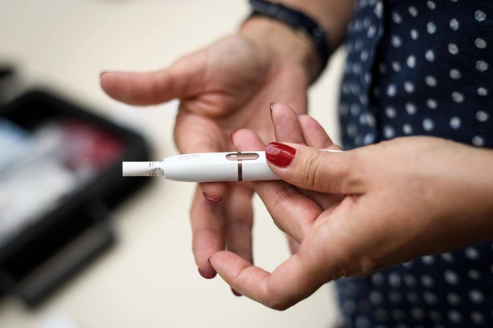 An iQOS electronic cigarette, which heats tobacco sticks but does not burn them, is shown at Philip Morris International’s research and development campus in Neuchatel, Switzerland on August 21, 2018. — AFP pic