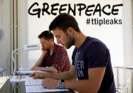 People read copies of the leaked TTIP negotiations inside a public reading room by the environmental campaign group Greenpeace in front of the Brandenburg Gate in Berlin, Germany, May 2, 2016. REUTERS/Fabrizio Bensch