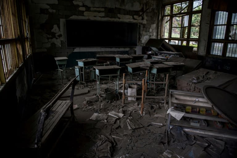 A thick layer of dust cakes the abandoned classroom that stands as a monument to those who lost their lives in the 2008 earthquake