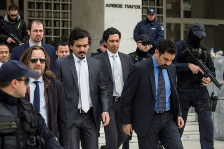 The eight Turkish soldiers, who fled to Greece in a helicopter and requested political asylum after a failed military coup against the government, are escorted by police officers as they leave the Supreme Court in Athens, Greece, January 23, 2017. REUTERS/Alkis Konstantinidis