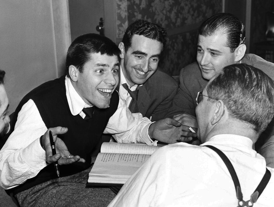 FILE - Comedian Jerry Lewis, left, meets with Ed Simmons, center, writer Norman Lear, background right, and producer Ernie Glucksman for "The Dean Martin and Jerry Lewis Show", in New York on May 15, 1951. Lear, the writer, director and producer who revolutionized prime time television with such topical hits as "All in the Family" and “Maude” and propelled political and social turmoil into the once-insulated world of sitcoms, died Tuesday, Dec. 5, 2023, at age 101. (AP Photo/Robert Kradin, File)