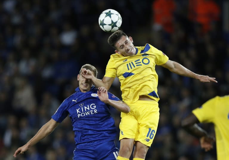 Leicester City's Marc Albrighton (L) and Porto's Hector Herrara vie for the ball during their UEFA Champions League group G match