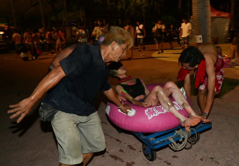 People tend to an injured woman after an explosion at the Formosa Fun Coast amusement park in the Pali district of New Taipei City on June 27, 2015