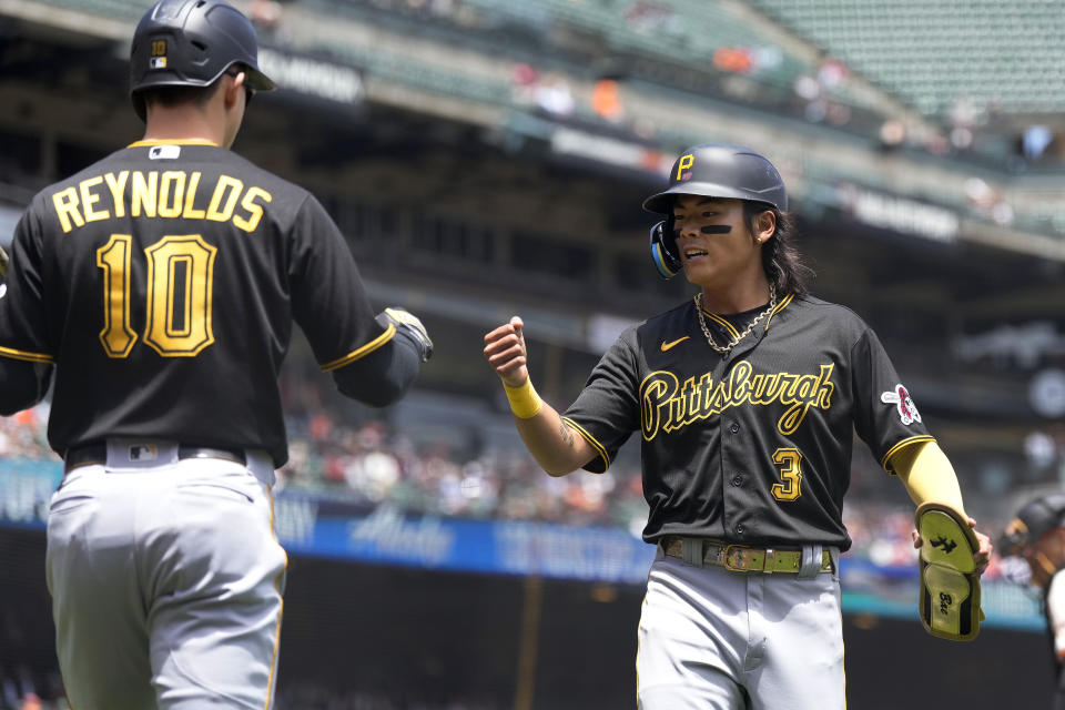 Pittsburgh Pirates' Ji Hwan Bae (3) is congratulated by Bryan Reynolds (10) after scoring a run on a double by Andrew McCutchen during the third inning of a baseball game against the San Francisco Giants in San Francisco, Wednesday, May 31, 2023. (AP Photo/Tony Avelar)