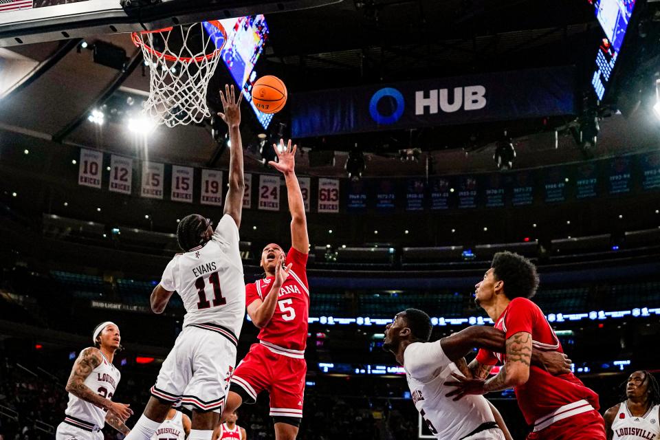 Indiana forward Malik Reneau (5) shoots over Louisville center Dennis Evans (11) in an NCAA college basketball game in the Empire Classic tournament in New York, Monday, Nov. 20, 2023.